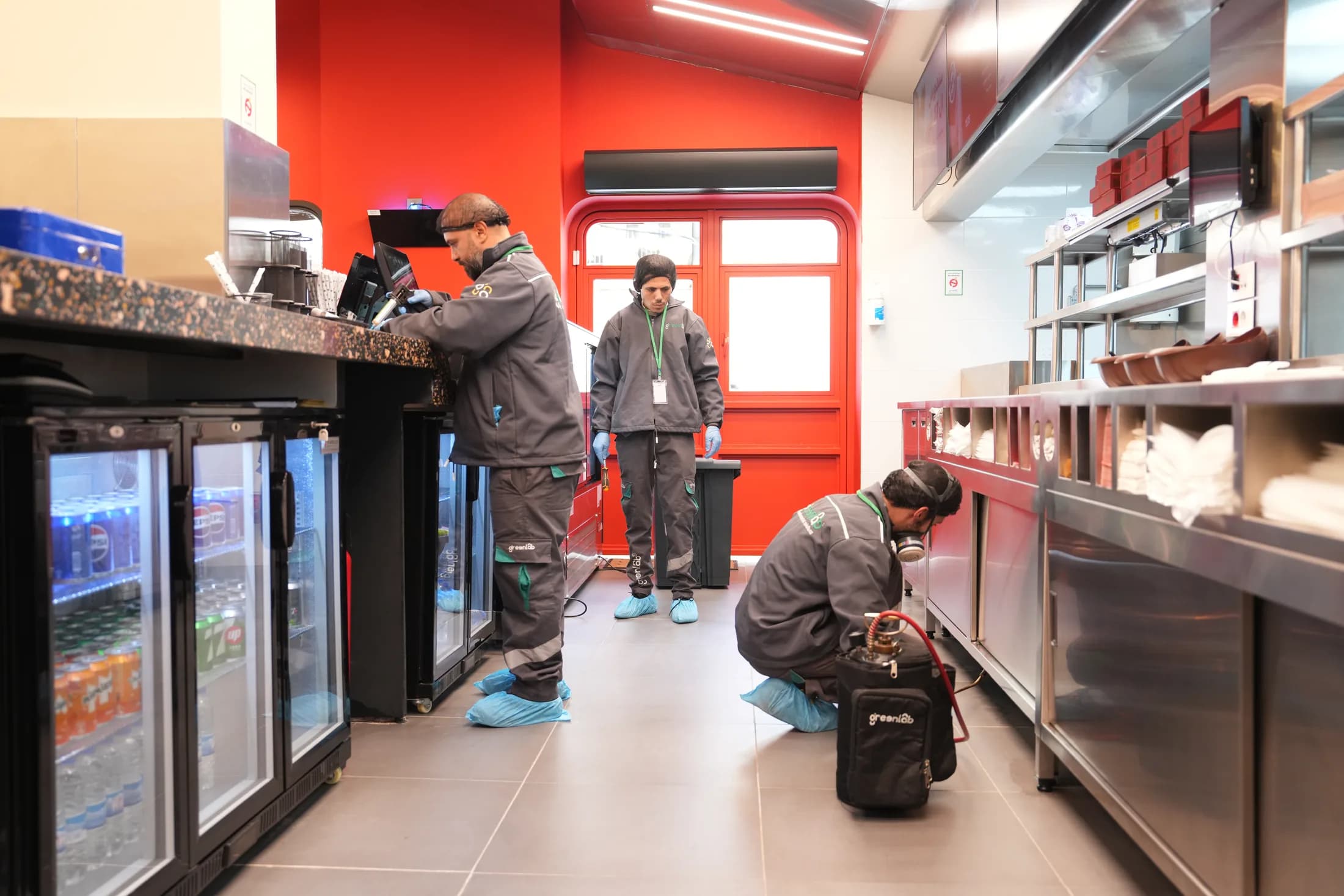 GreenLab technicians servicing a commercial kitchen.