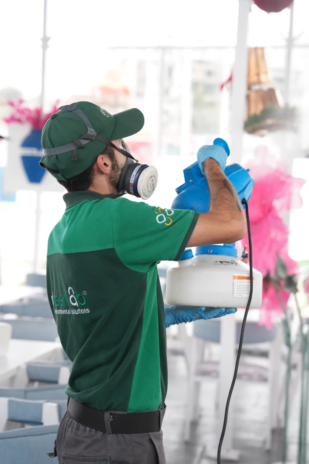 GreenLab technician servicing a hand hygiene fixture in a commercial environment.